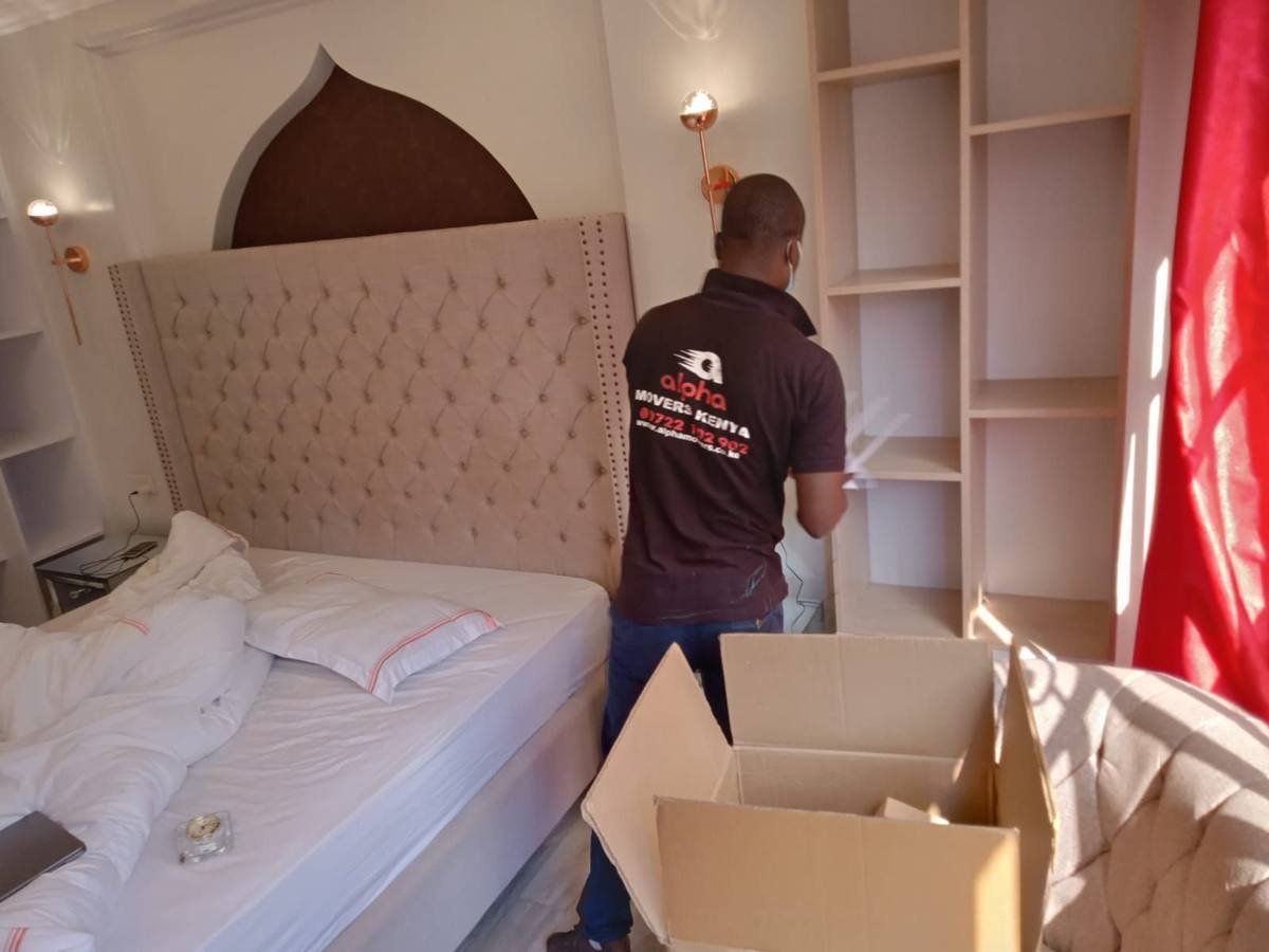 Movers disassembling a bed frame