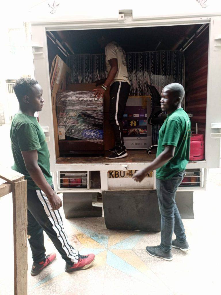 Movers carrying a large television