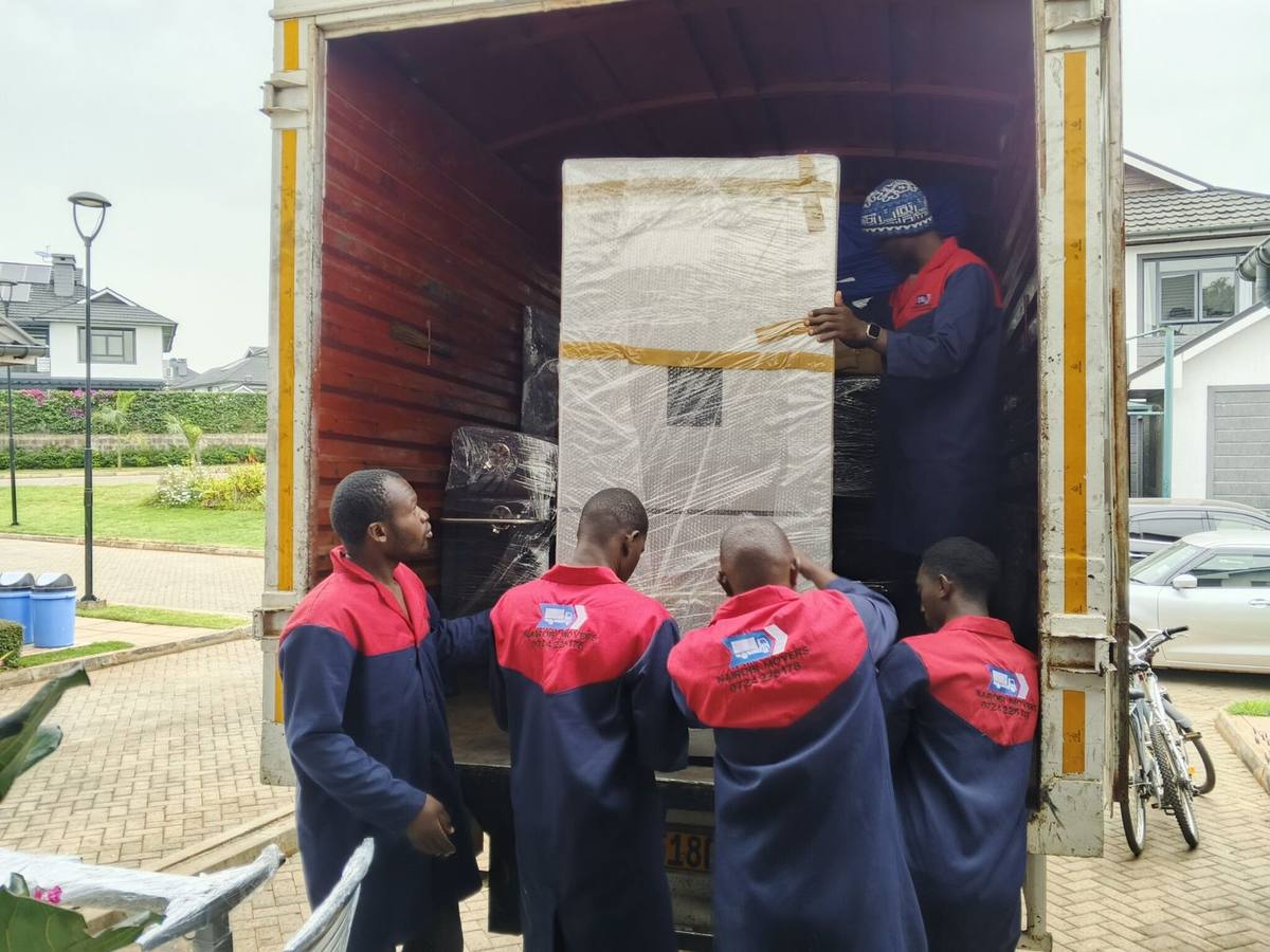 Crew loading a truck for the Nairobi to Nakuru route