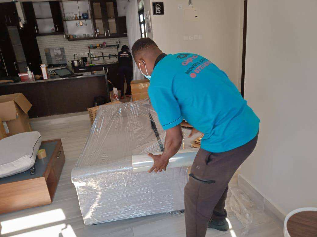 Mover wrapping a mattress in protective film